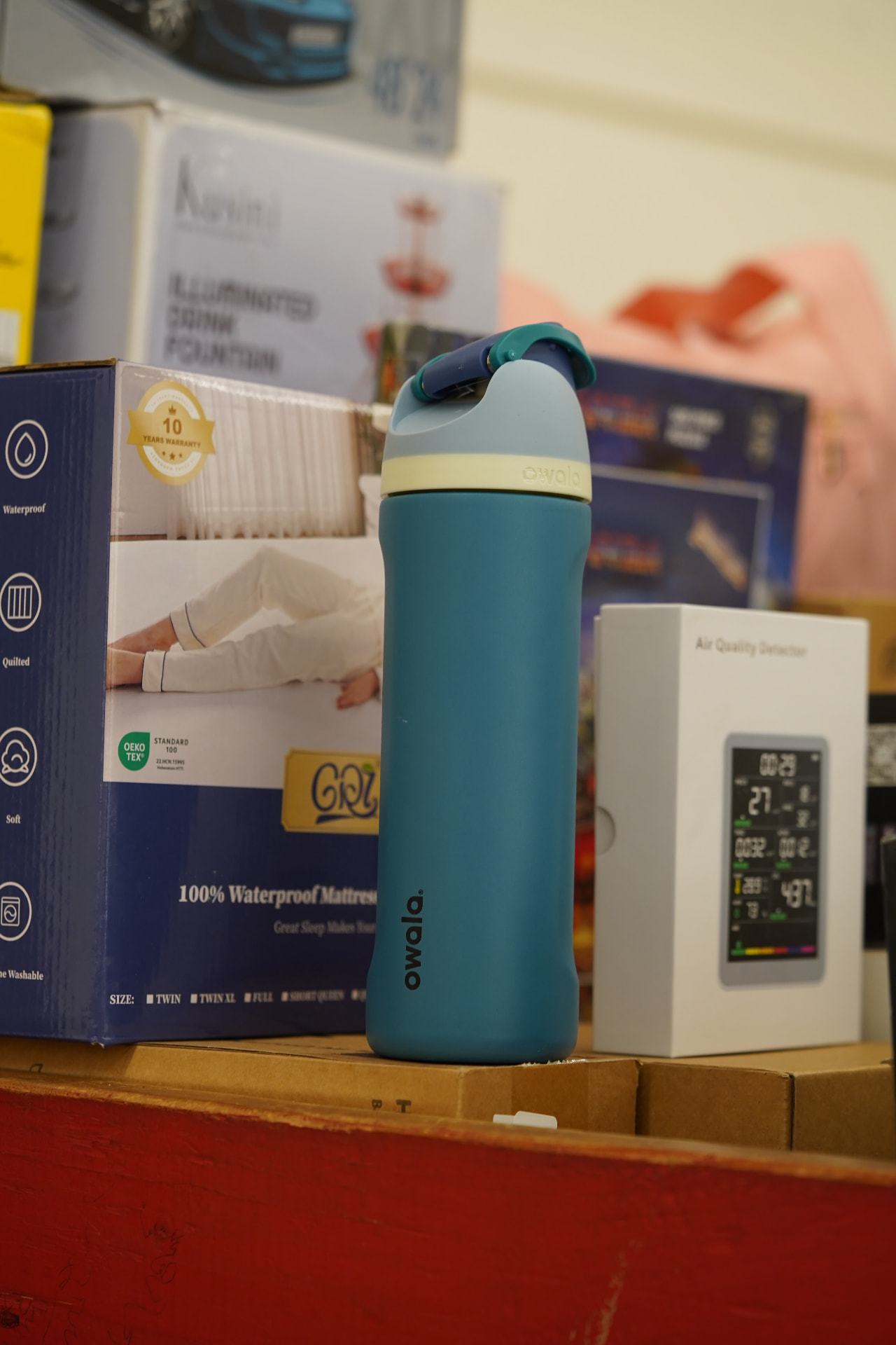 Reusable drink bottle and boxed home goods found at Deals on Wheels