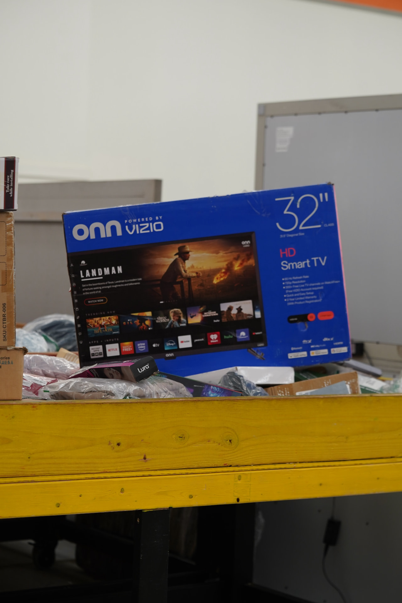 Boxed television displayed in a Deals on Wheels merchandise bin